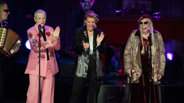 Annie Lennox, left, and Brandi Carlile, center, applaud Joni Mitchell after she sang at the 2024 Library of Congress Gershwin Prize for Popular Song tribute concert honoring Elton John and Bernie Taupin at DAR Constitution Hall on Wednesday, March 20, 202